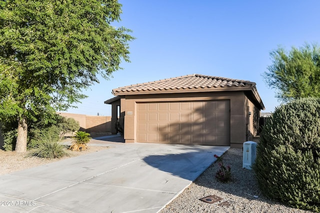 24163 N Cotton Cir, Florence, AZ 85132 - view of front of house with a tiled roof, a garage, stucco siding, and driveway