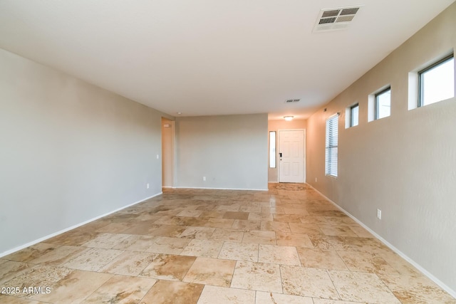 24163 N Cotton Cir, Florence, AZ 85132 - empty room featuring stone tile floors and baseboards