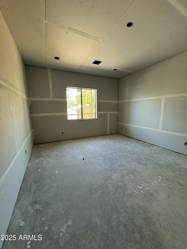 spare room featuring unfinished concrete floors