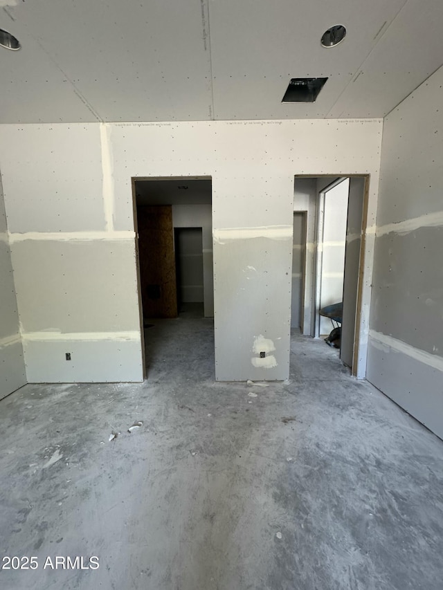 unfurnished bedroom with concrete floors