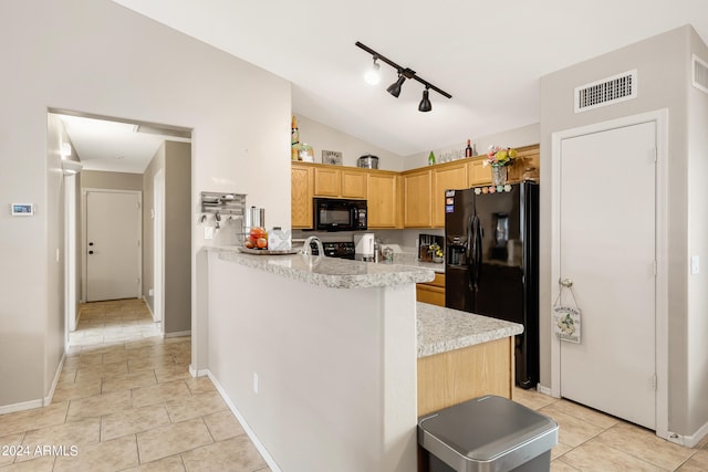 kitchen featuring lofted ceiling, black appliances, rail lighting, kitchen peninsula, and light brown cabinetry