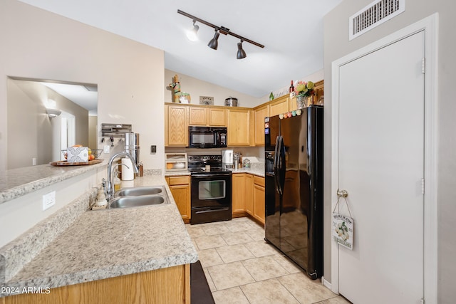 kitchen featuring lofted ceiling, light tile patterned floors, sink, black appliances, and light stone countertops