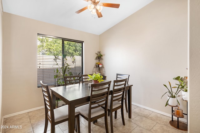 dining space featuring vaulted ceiling, light tile patterned floors, and ceiling fan