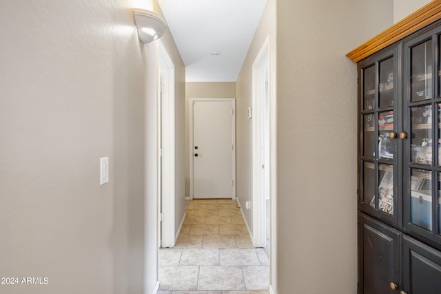 hall with light tile patterned floors