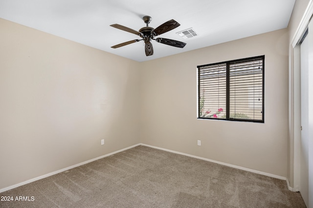 unfurnished room featuring ceiling fan and light colored carpet