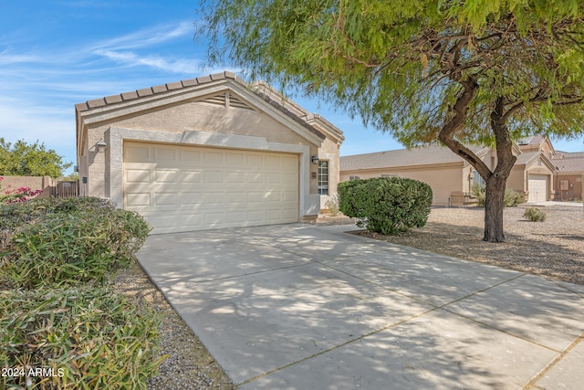 ranch-style home featuring a garage