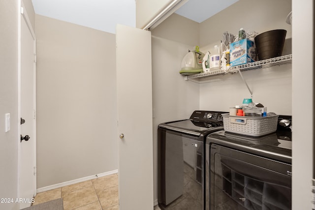 laundry area featuring separate washer and dryer and light tile patterned flooring