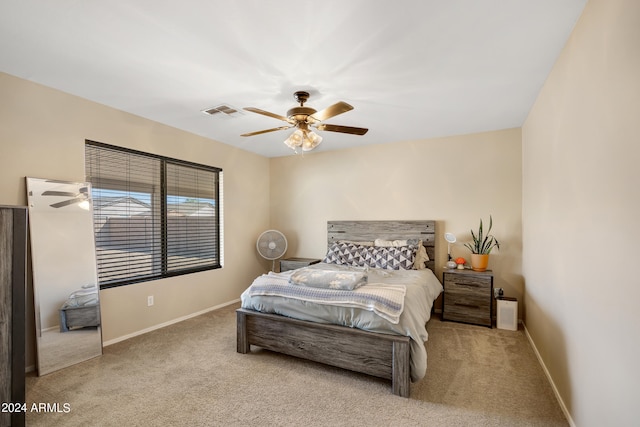 bedroom featuring light carpet and ceiling fan