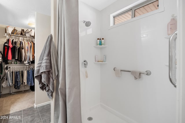 bathroom with tile patterned floors and curtained shower