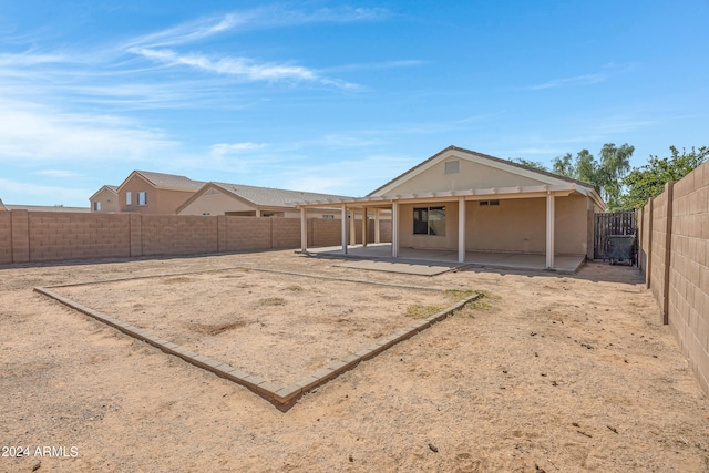 back of house with a patio