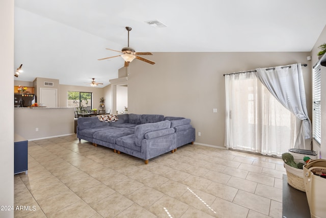 living room featuring light tile patterned flooring, high vaulted ceiling, and ceiling fan