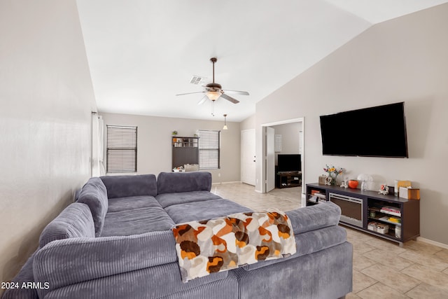 living room featuring ceiling fan, light tile patterned flooring, and lofted ceiling