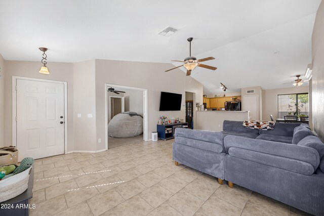 tiled living room featuring lofted ceiling