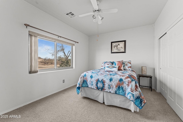 carpeted bedroom featuring a closet and ceiling fan