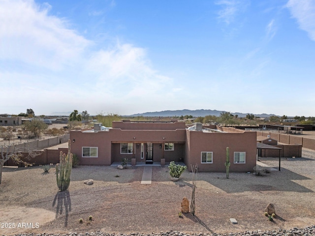 view of front of property featuring a mountain view and a patio