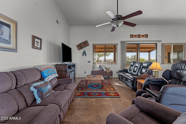 living room featuring crown molding, ceiling fan, and dark tile patterned floors