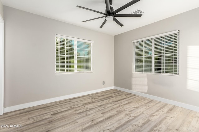 spare room with light wood-type flooring and ceiling fan