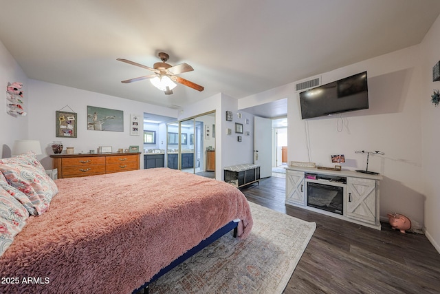 14412 N 39th Ave, Phoenix, AZ 85053 - bedroom featuring dark wood-type flooring, ceiling fan, baseboards, and ensuite bathroom
