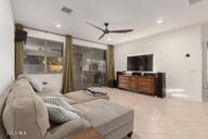14687 W Amelia Ave, Goodyear, AZ 85395 - living room featuring a ceiling fan and recessed lighting