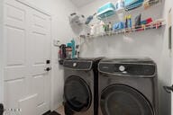 14687 W Amelia Ave, Goodyear, AZ 85395 - laundry room featuring washing machine and clothes dryer