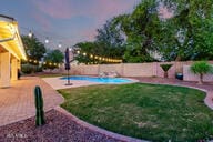 14687 W Amelia Ave, Goodyear, AZ 85395 - fenced backyard with a patio area