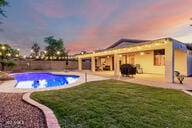 14687 W Amelia Ave, Goodyear, AZ 85395 - view of pool featuring a patio area and a yard