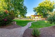14687 W Amelia Ave, Goodyear, AZ 85395 - view of home's community with a lawn and a pergola