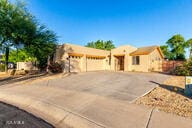 14687 W Amelia Ave, Goodyear, AZ 85395 - pueblo revival-style home with concrete driveway