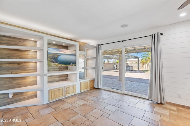 entryway featuring wooden walls and a sunroom