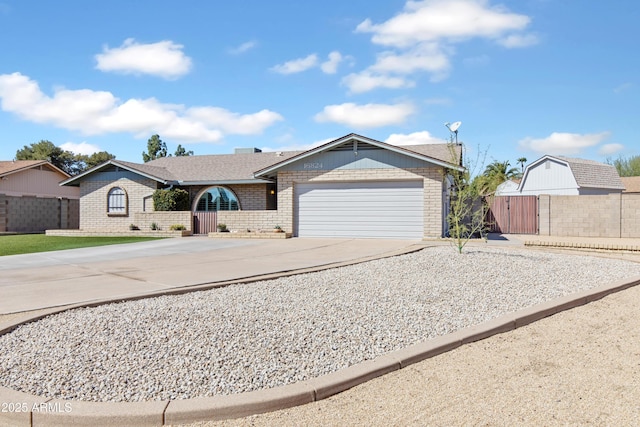 single story home featuring fence, brick siding, concrete driveway, and a gate