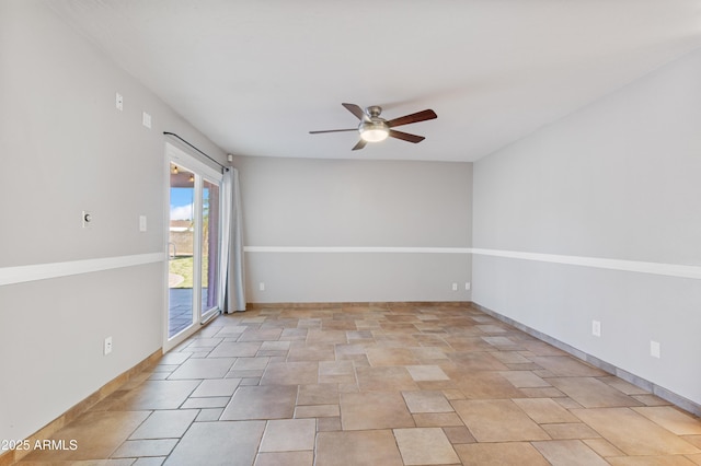 unfurnished room featuring baseboards and ceiling fan