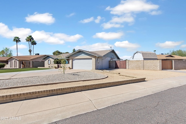 ranch-style home featuring a gate, fence, an attached garage, concrete driveway, and brick siding