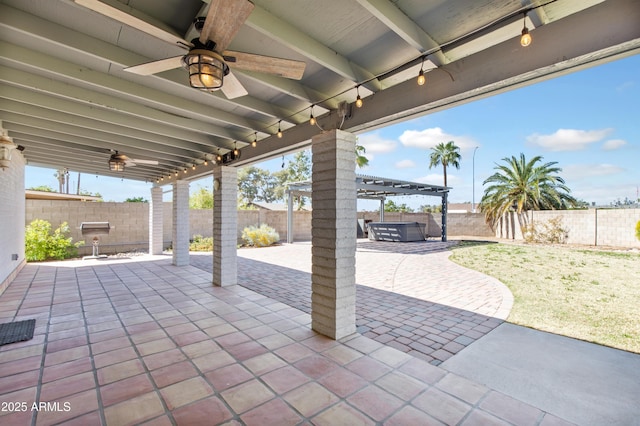 view of patio / terrace featuring a jacuzzi, a fenced backyard, ceiling fan, and a pergola