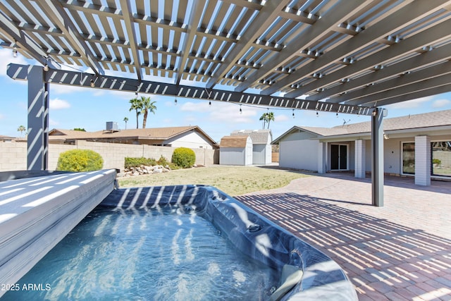 view of pool featuring fence, a storage shed, an outdoor structure, a patio area, and a pergola