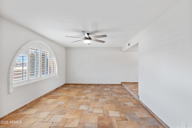 spare room with visible vents, baseboards, and a ceiling fan