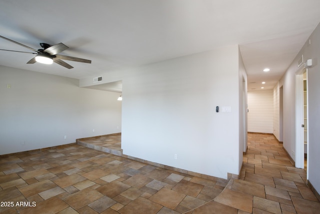 spare room featuring recessed lighting, a ceiling fan, visible vents, and stone finish flooring