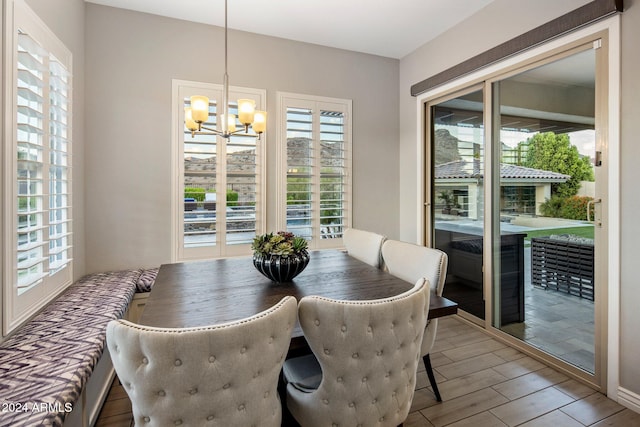 dining area featuring a chandelier, hardwood / wood-style floors, and a healthy amount of sunlight