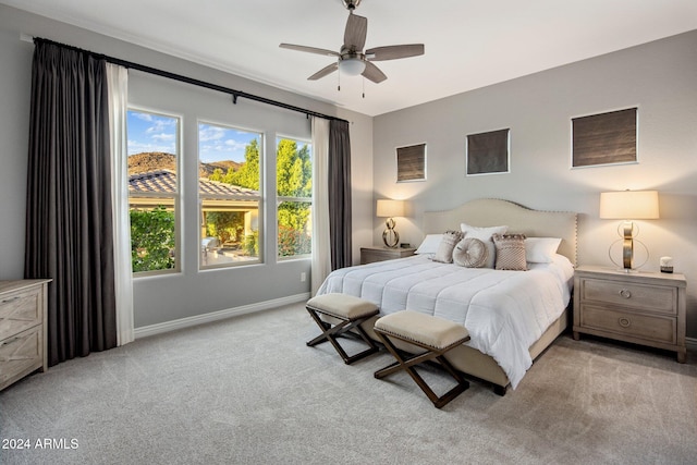 bedroom with ceiling fan and light colored carpet