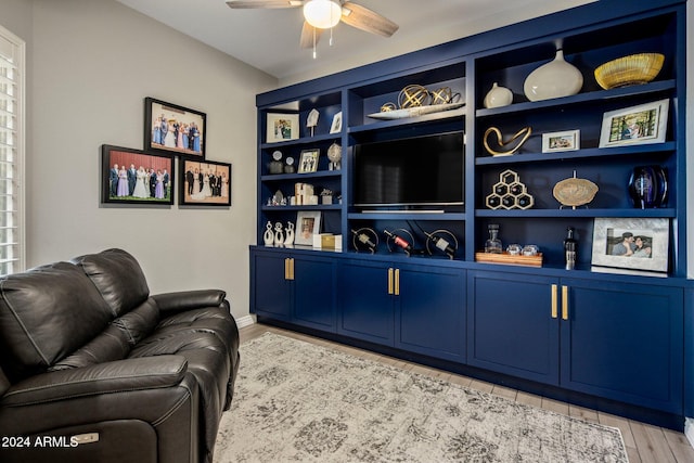 living room with light hardwood / wood-style flooring and ceiling fan