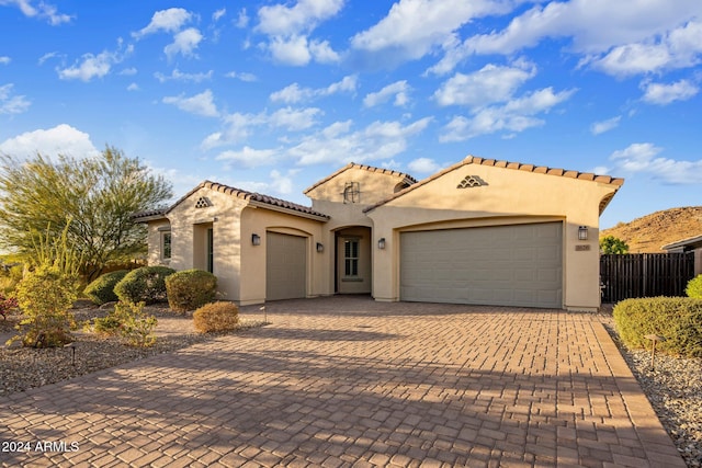 mediterranean / spanish home featuring a garage