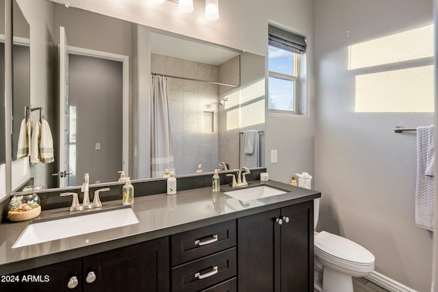 bathroom featuring vanity, toilet, and a shower with shower curtain