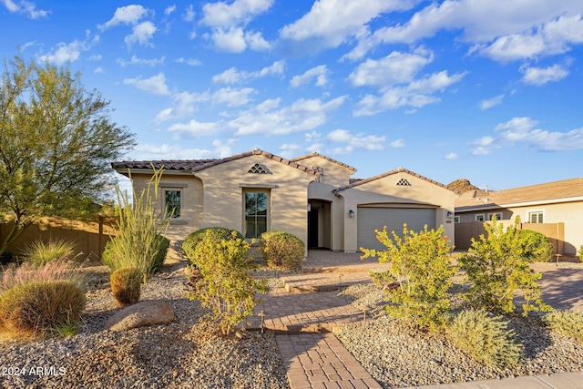 mediterranean / spanish-style home with a garage