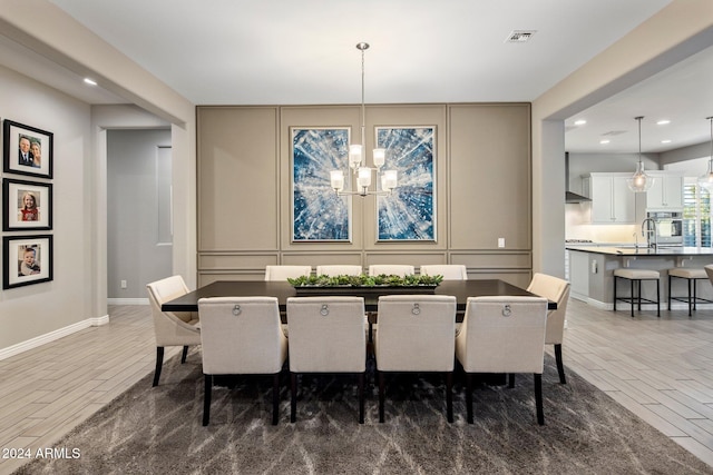 dining area featuring sink, dark hardwood / wood-style flooring, and an inviting chandelier