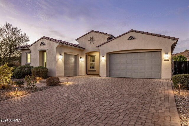 mediterranean / spanish-style home featuring a garage