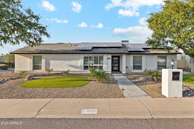 view of front of home with solar panels