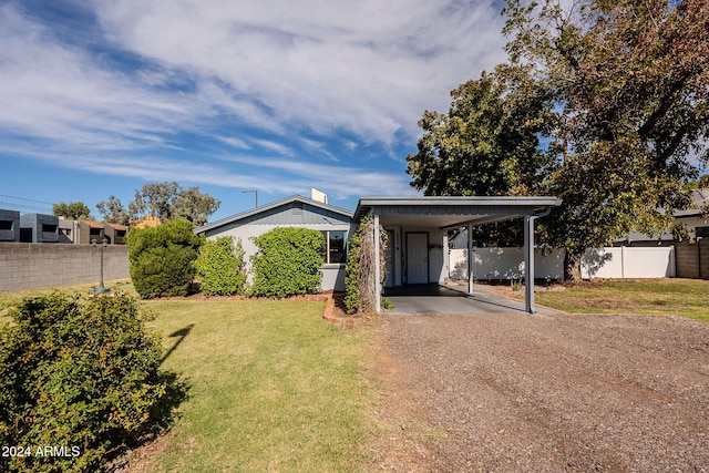 single story home featuring a front lawn and a carport