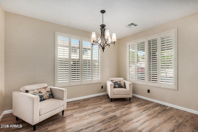 9566 N 83rd Dr, Peoria, AZ 85345 - sitting room featuring a wealth of natural light, visible vents, wood finished floors, and an inviting chandelier