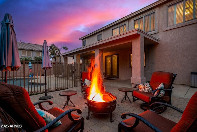 9566 N 83rd Dr, Peoria, AZ 85345 - patio terrace at dusk with a fire pit and fence
