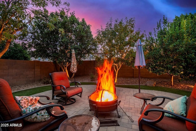 9566 N 83rd Dr, Peoria, AZ 85345 - patio terrace at dusk with a fire pit and a fenced backyard