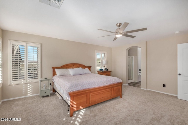 9566 N 83rd Dr, Peoria, AZ 85345 - bedroom featuring arched walkways, visible vents, light colored carpet, and baseboards